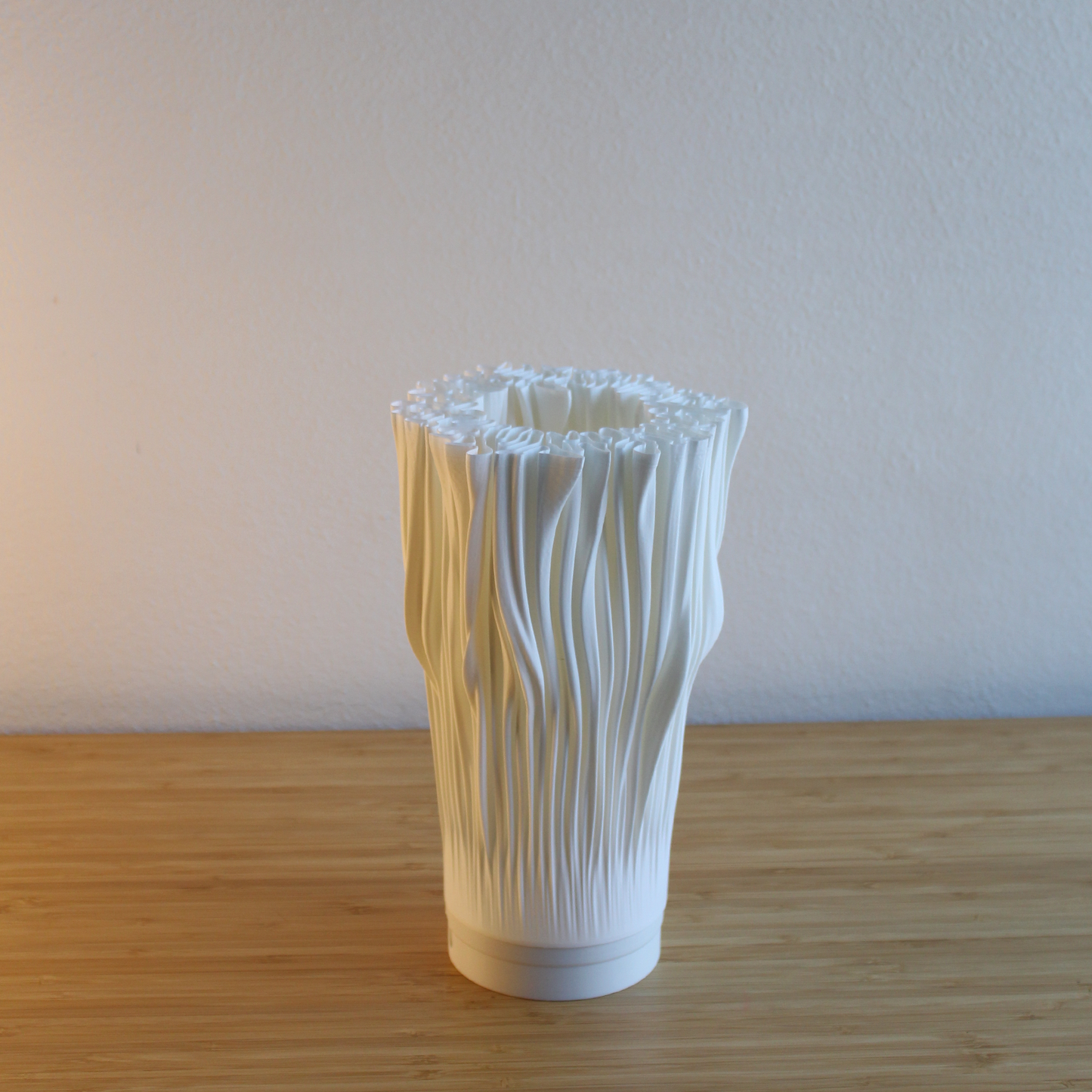 Unlit Portable Coral Lamp on a natural wooden surface against a white wall. Highlights the lamp's unique organic, sculptural form.