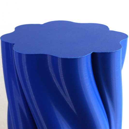 Modern blue 3D printed Dune Side Table styled in minimalist living room interior.