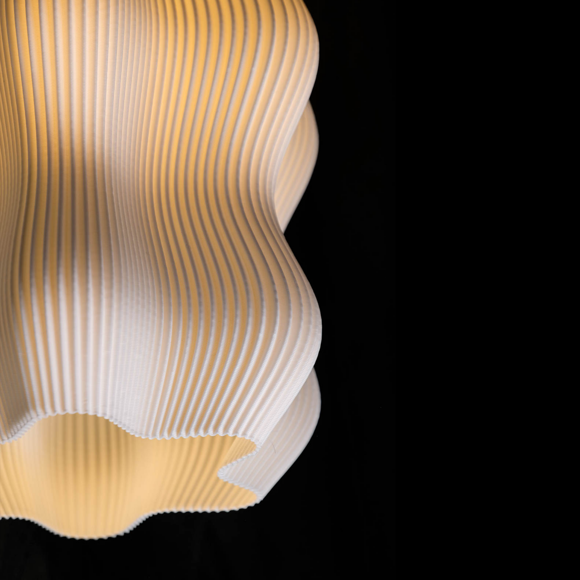 Minimalist ceiling light by Namami Studio in front of black background.