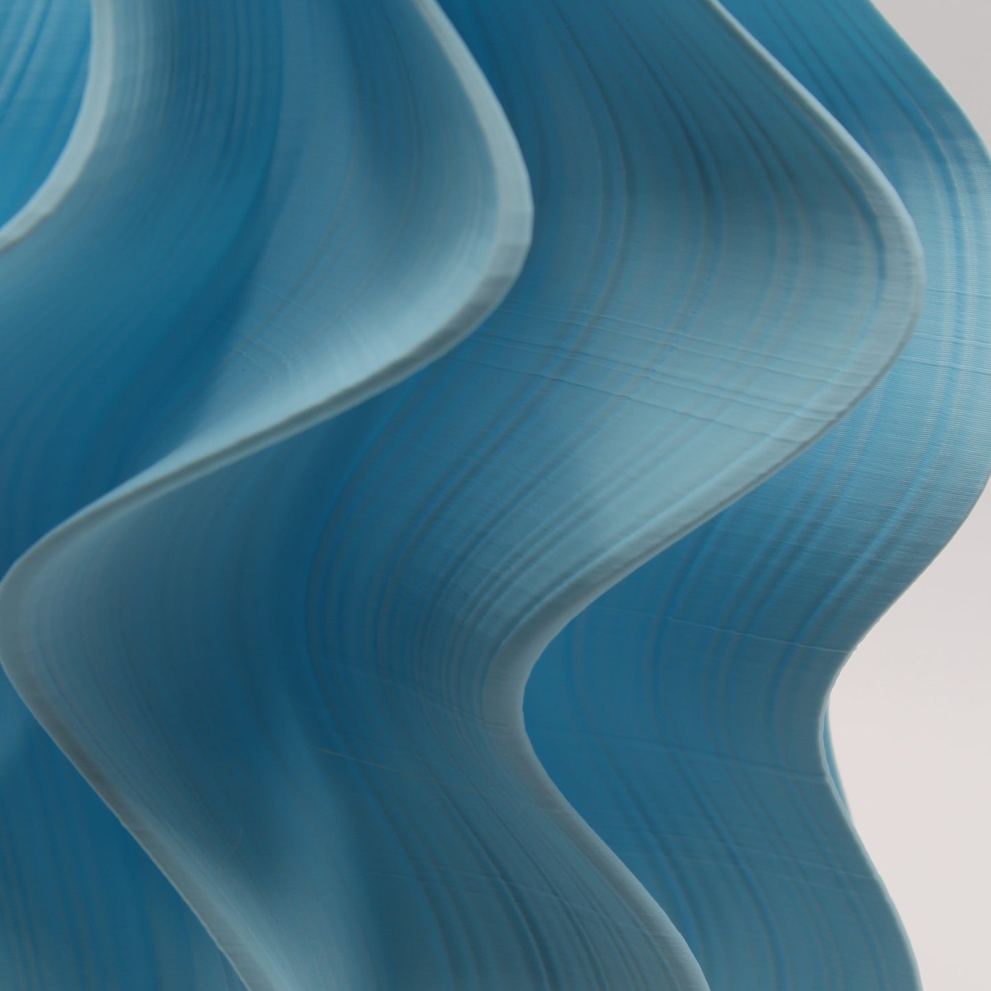 Blue wavy abstract design Iris Lamp on a light gray background