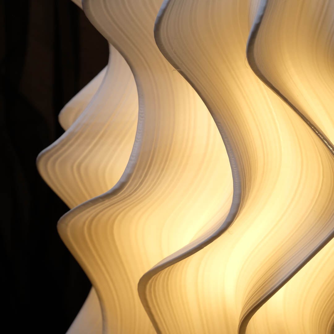 Iris Wave-like lamp with wavy design on a dark background
