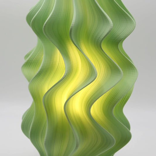 Iris Wave-patterned green wall lamp on a white background