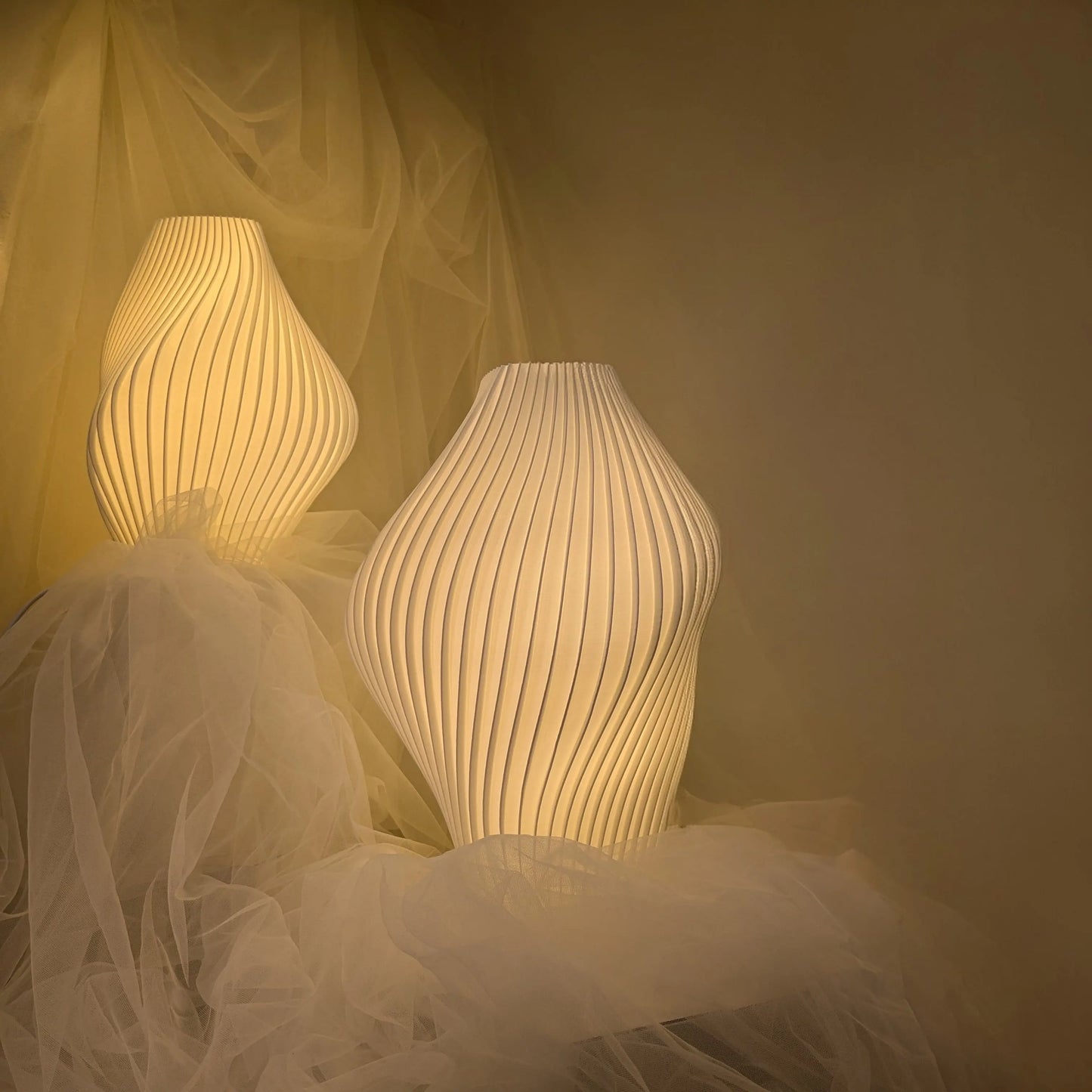 Pleat Lamp Namami, Pleat Lamp glowing softly in curated reading corner