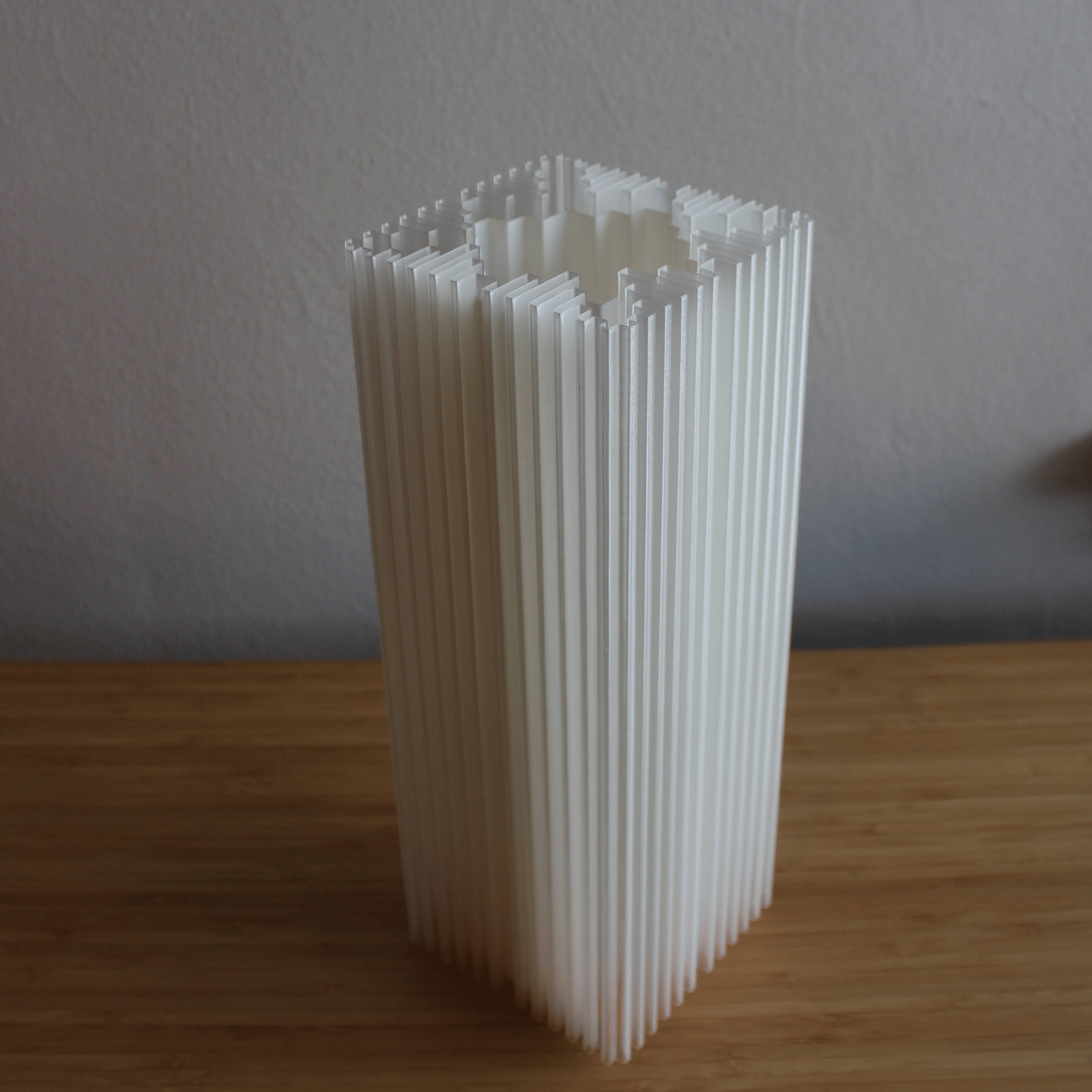 Architectural shard lamp close-up showing rhythm and simplicity of Brutalist design.