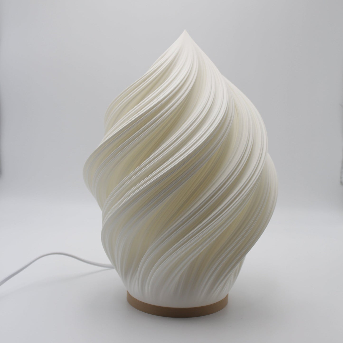Soft Serve Lamp on a wooden shelf, combining Scandinavian-inspired form with soft ambient glow.