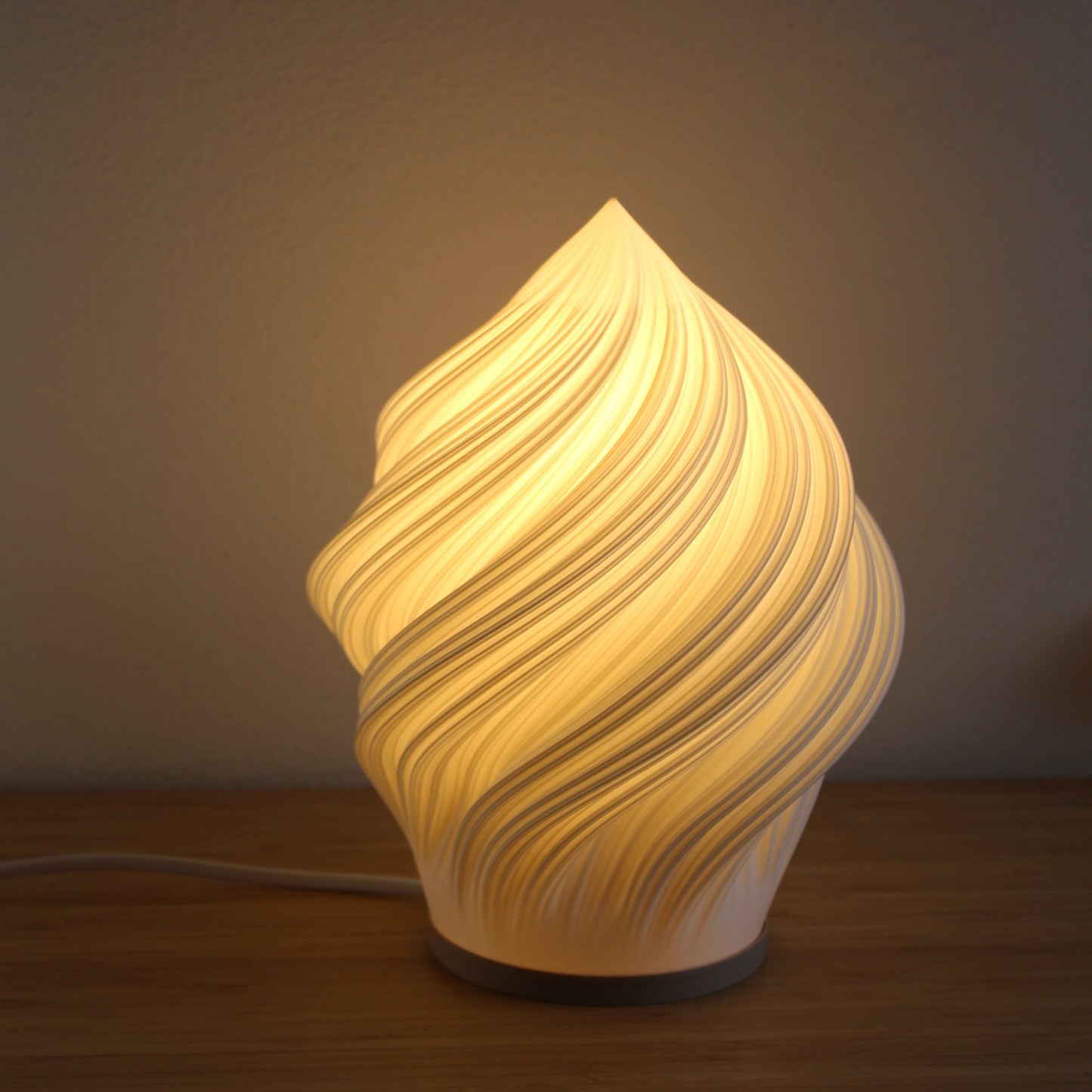 Soft Serve Lamp in white — modern 3D printed table lamp inspired by ice cream swirl design.