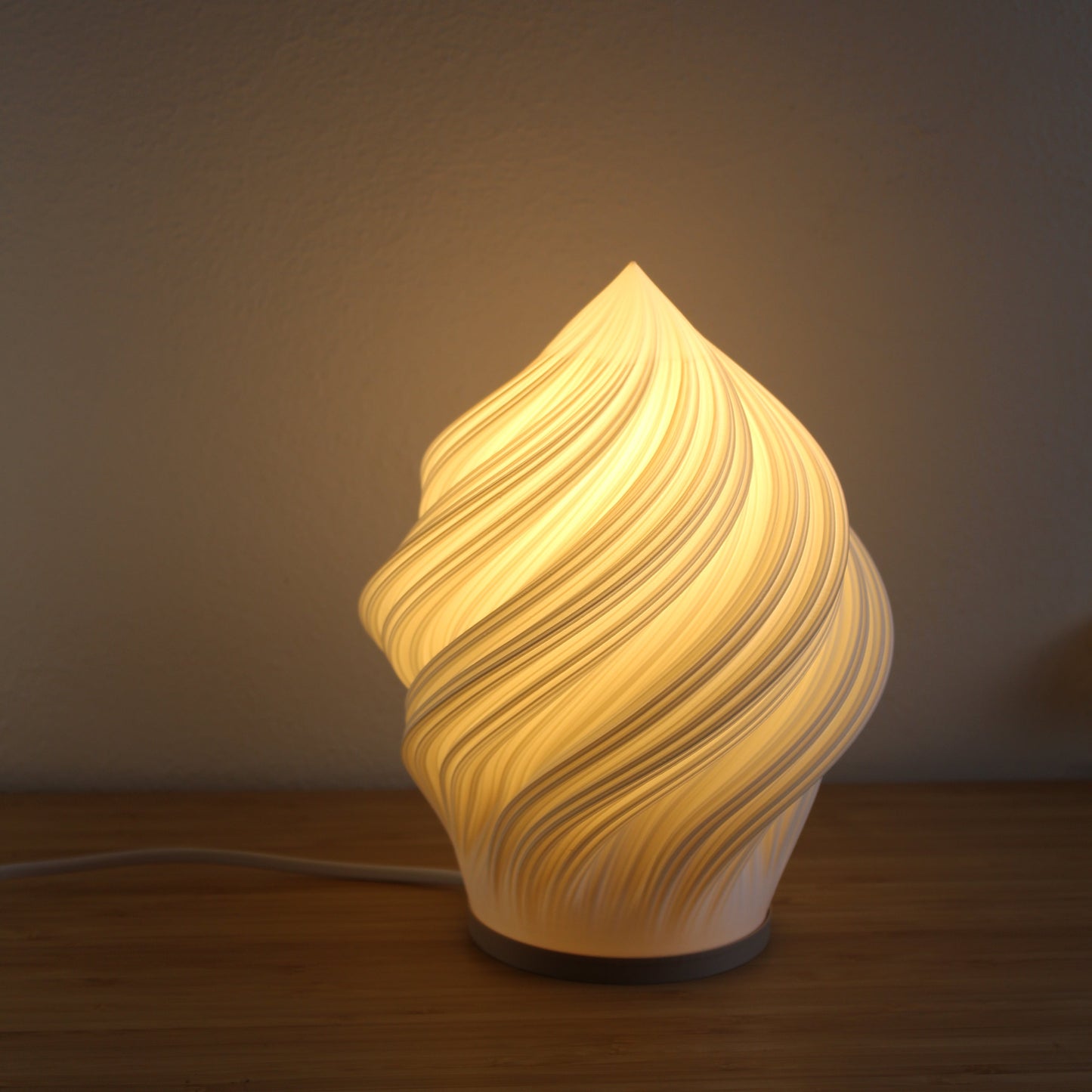 Decorative Soft Serve light fixture with a warm glow on a neutral background