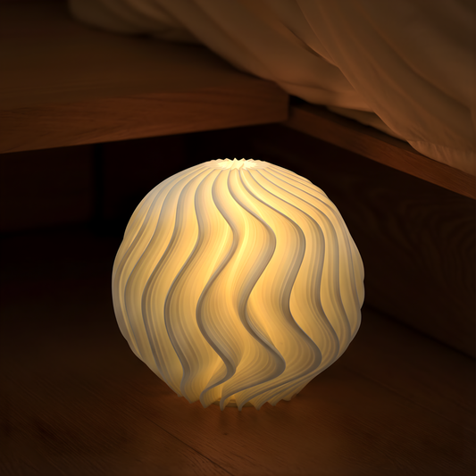 White Orb Lamp emitting a warm glow on a wooden floor beside a bed, creating soft ambient lighting.