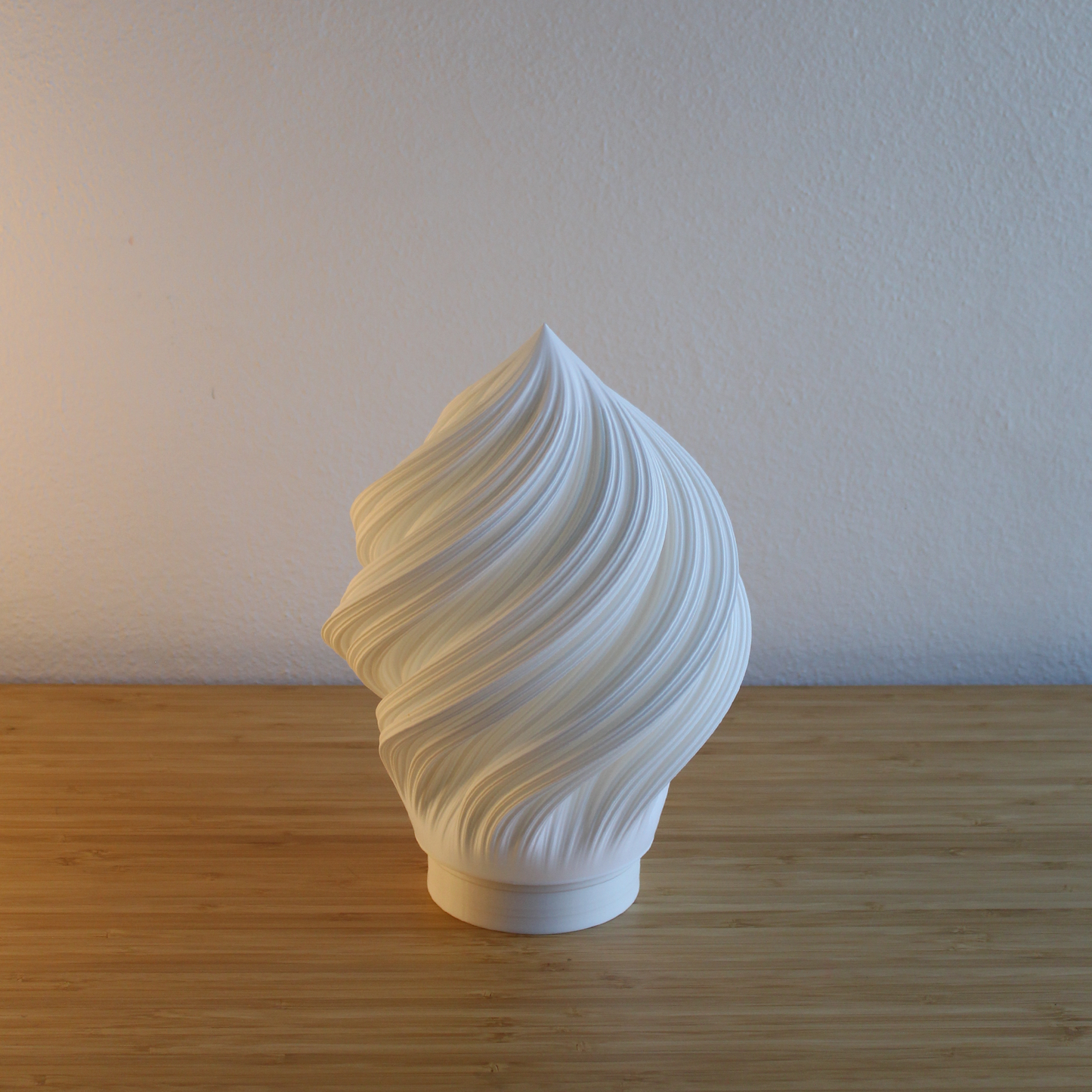 Close-up of the Portable Soft Serve Lamp's flowing, pleated texture made from sustainable recycled PLA. Shows the sleek base and craftsmanship.