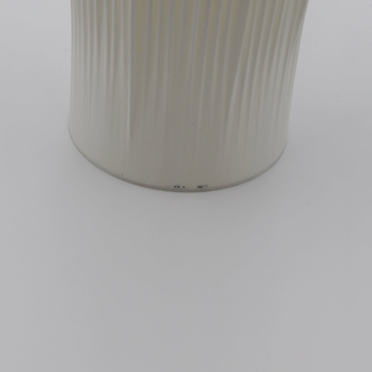 A creme-colored Coral Lamp with minor imperfections near the base.