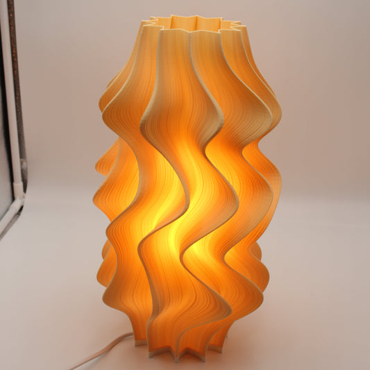A 35cm Iris Lamp in a new light orange color, a sculptural test edition.