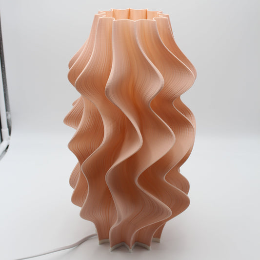 A sculptural Peach Iris Lamp, a seconds piece with a small cosmetic imperfection at the base.