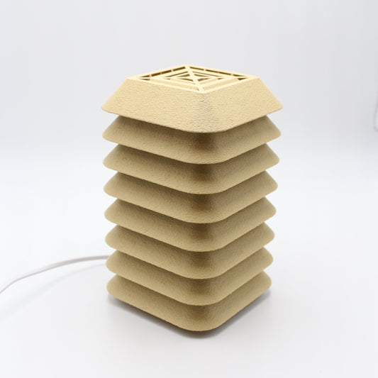 Beige kengo to lamp with geometric design on a white background