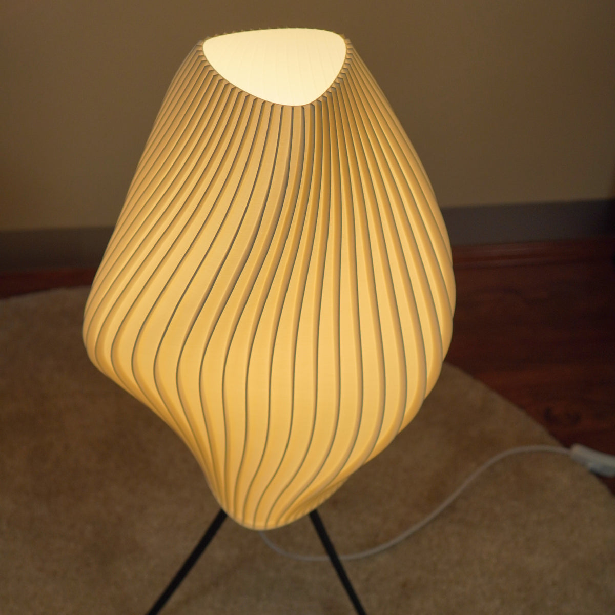 View of the top opening and pleated rim of the Crème Pleat Floor Lamp.