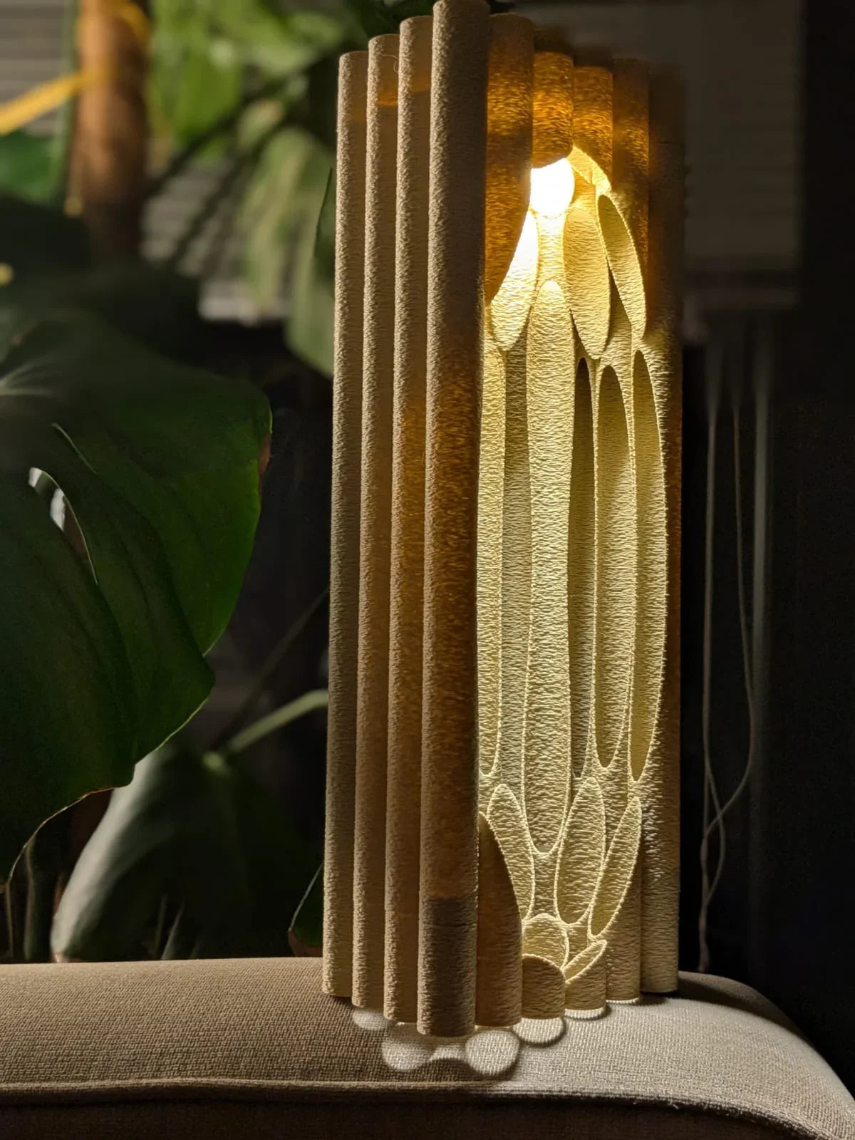 A bedroom corner with the Namami Silo Night Light casting a gentle, warm glow on the wall