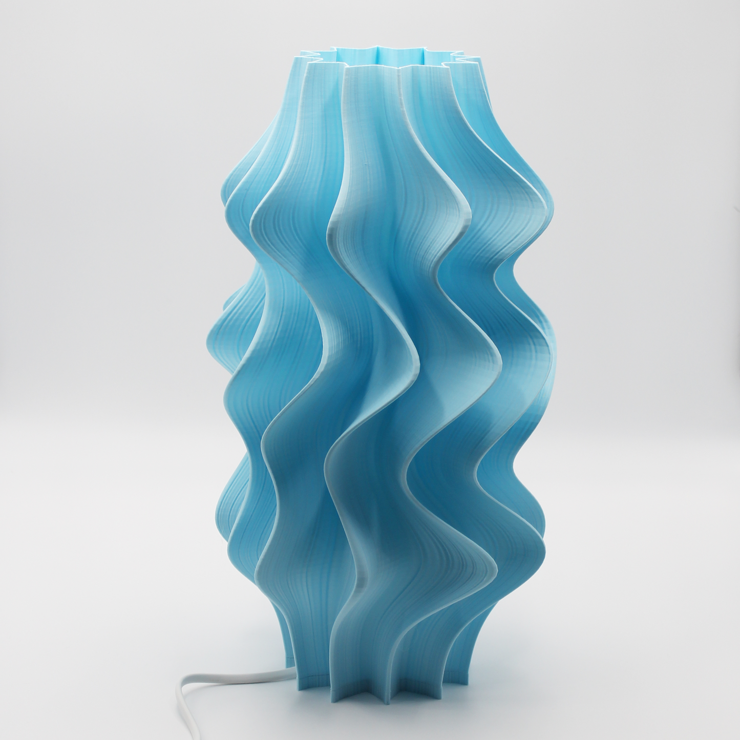 Blue wavy Iris table lamp on a white background