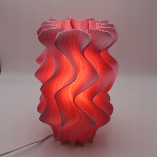 A vibrant Flamingo-colored Iris lamp, cropped at the top, showing the unfinished, raw form.