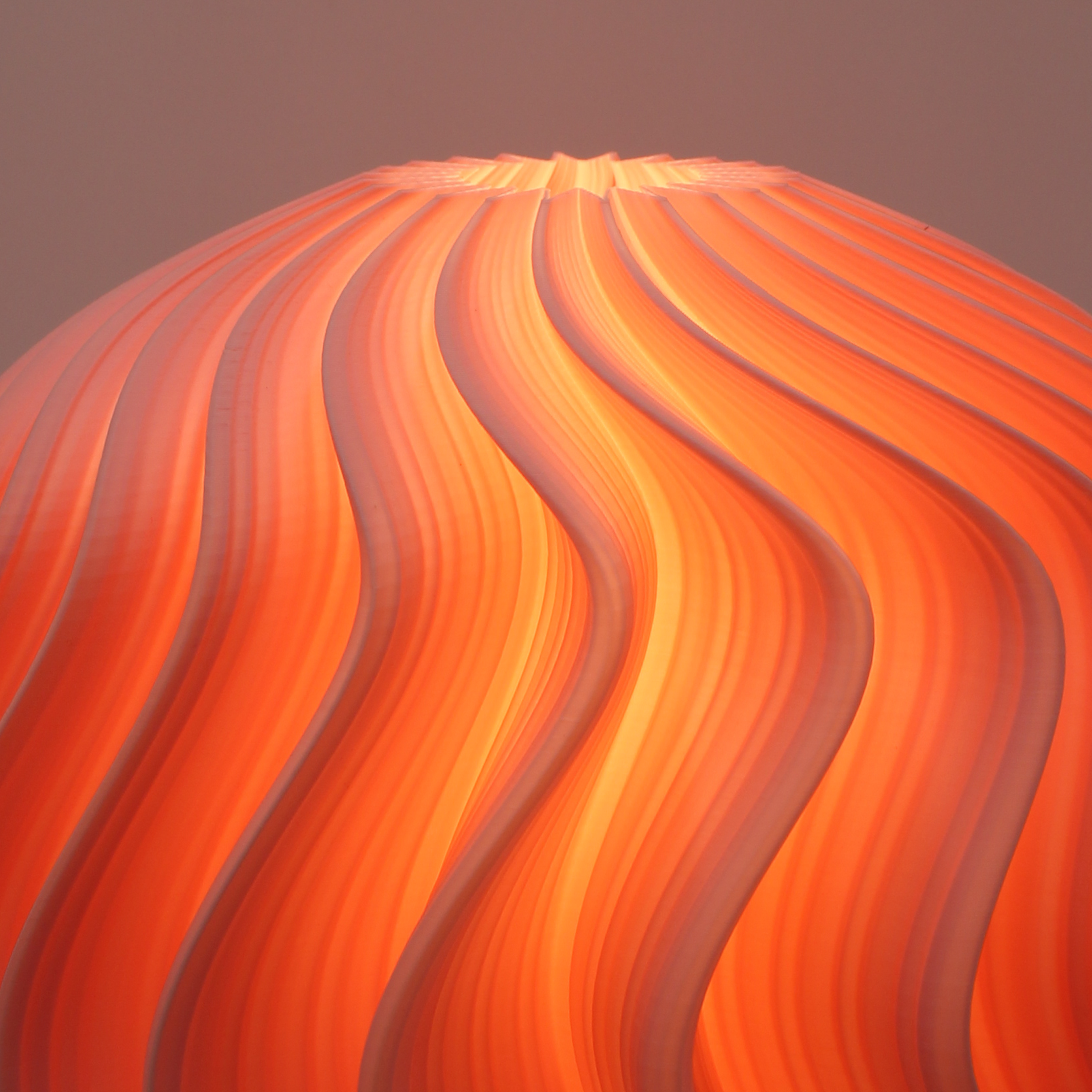wavy pattern orb lamp in flamingo by namami studio on a gradient background