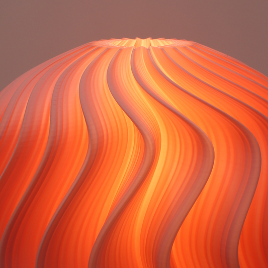 wavy pattern orb lamp in flamingo by namami studio on a gradient background