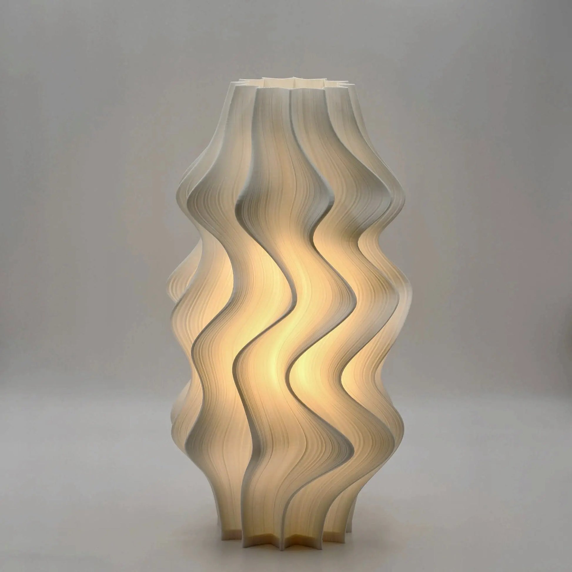 Soft petal-like form of Iris Lamp in bedroom setting