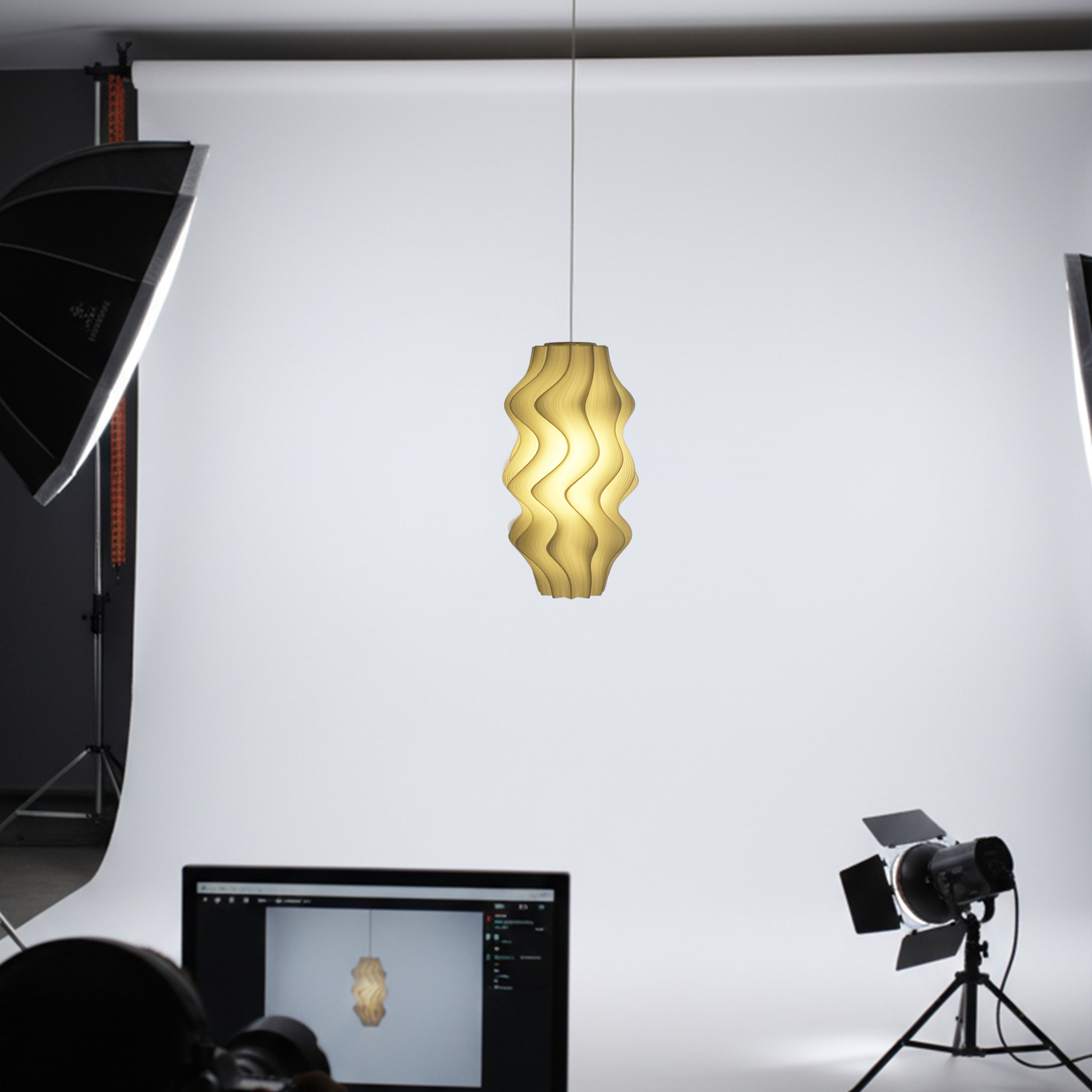 Irris Pendant light being photographed in a studio with lighting equipment and computer screen.