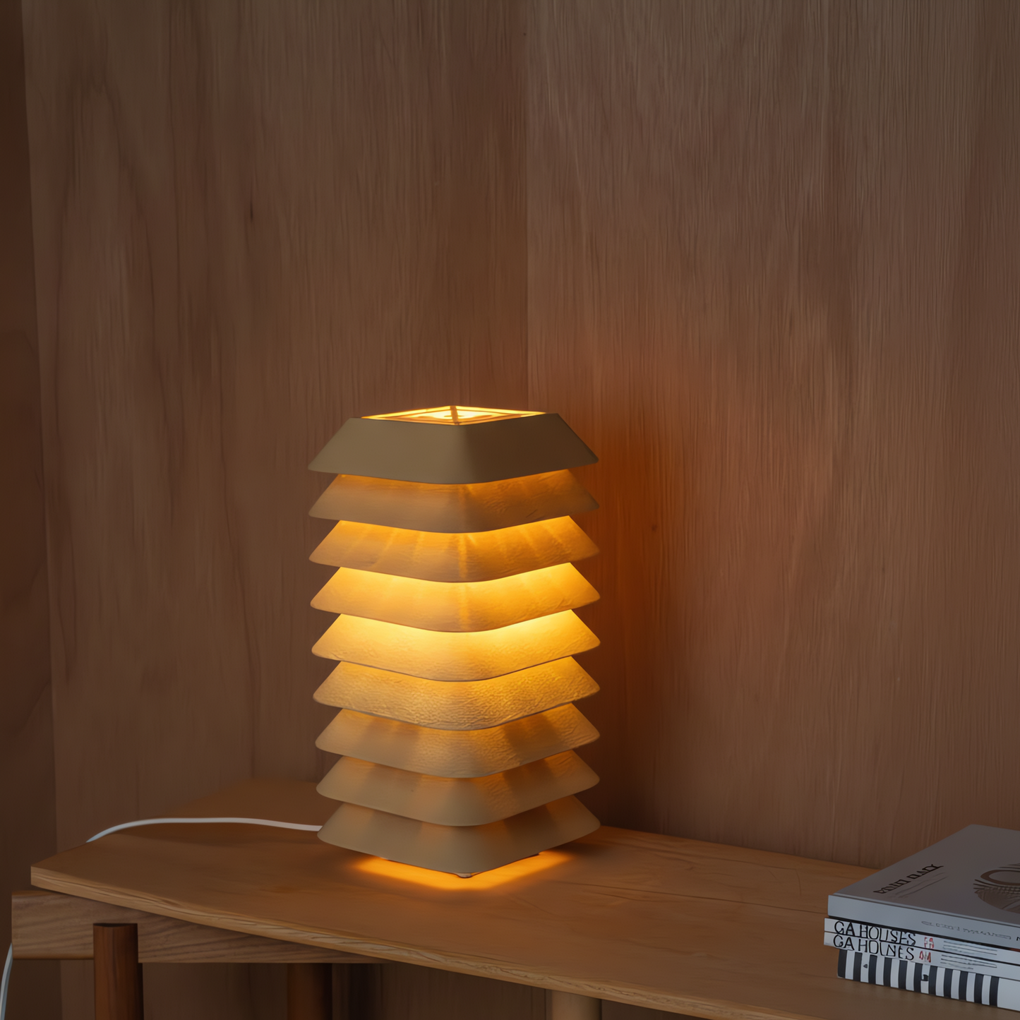 Kengo Tō lamp glowing softly on a timber table against a wood wall, showing warm ambient light and architectural layers.