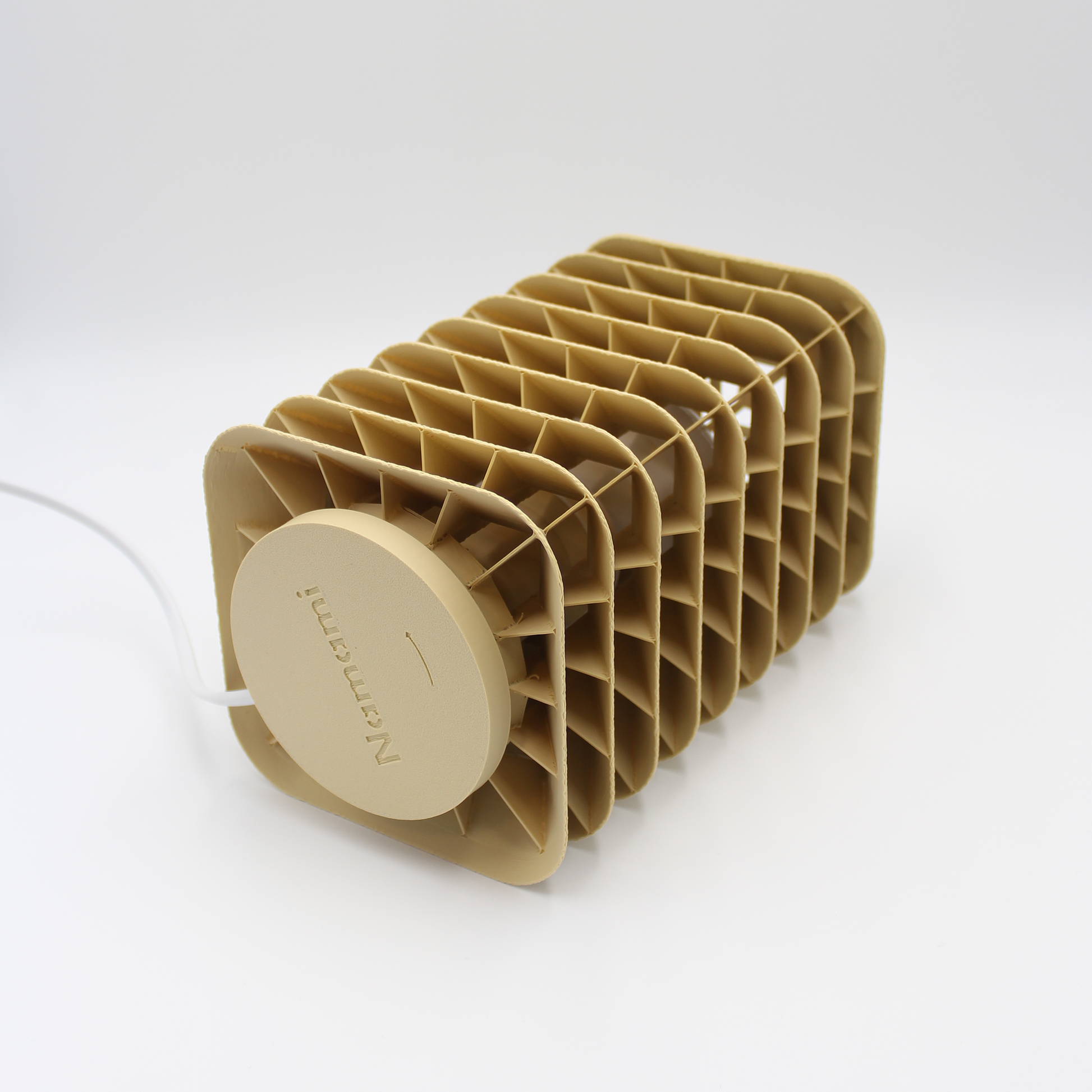 Detailed studio shot of the Kengo Tō lamp’s layered geometric design with cable visible against a white backdrop
