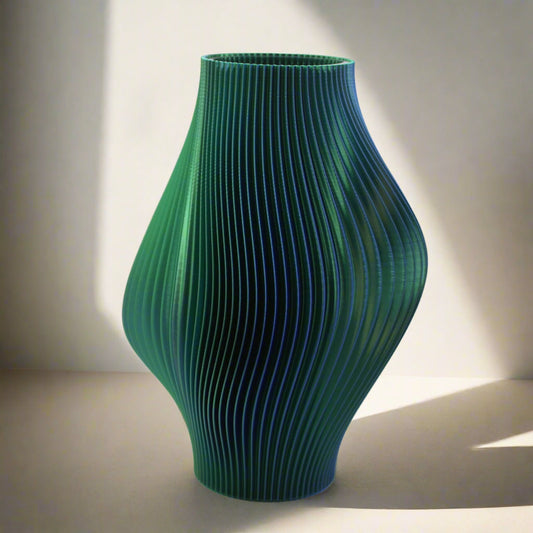 Blue - Green ripple vase on a white background