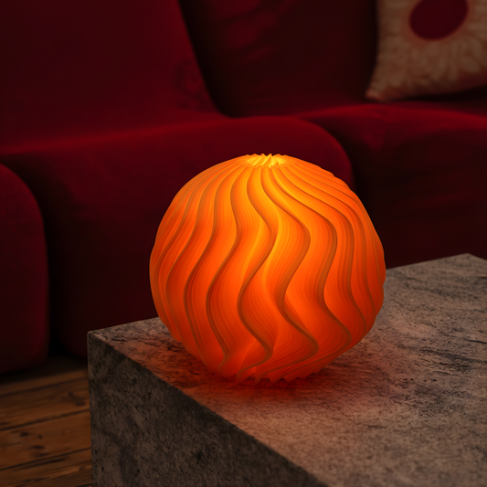 Orange Orb Lamp glowing warmly on a textured stone table in a living room with a red sofa in the background.