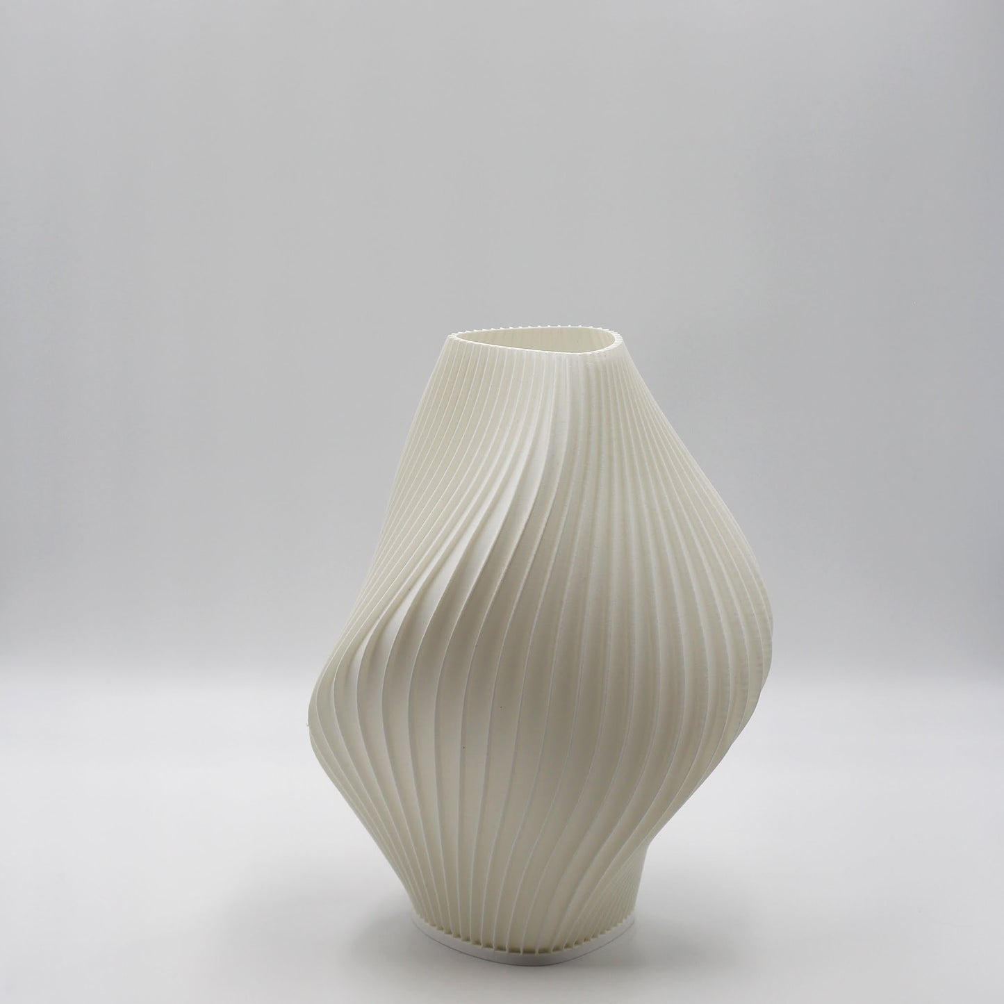 White ribbed pleat lamp on a light gray background
