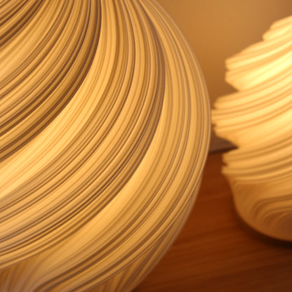 Minimal Scandinavian style 3D printed lamp with swirling texture, Soft Serve Lamp in white.