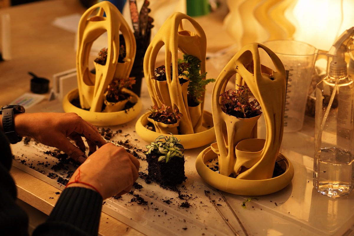 Hands planting Azulik sculptural terrariums in the Namami Studio workshop