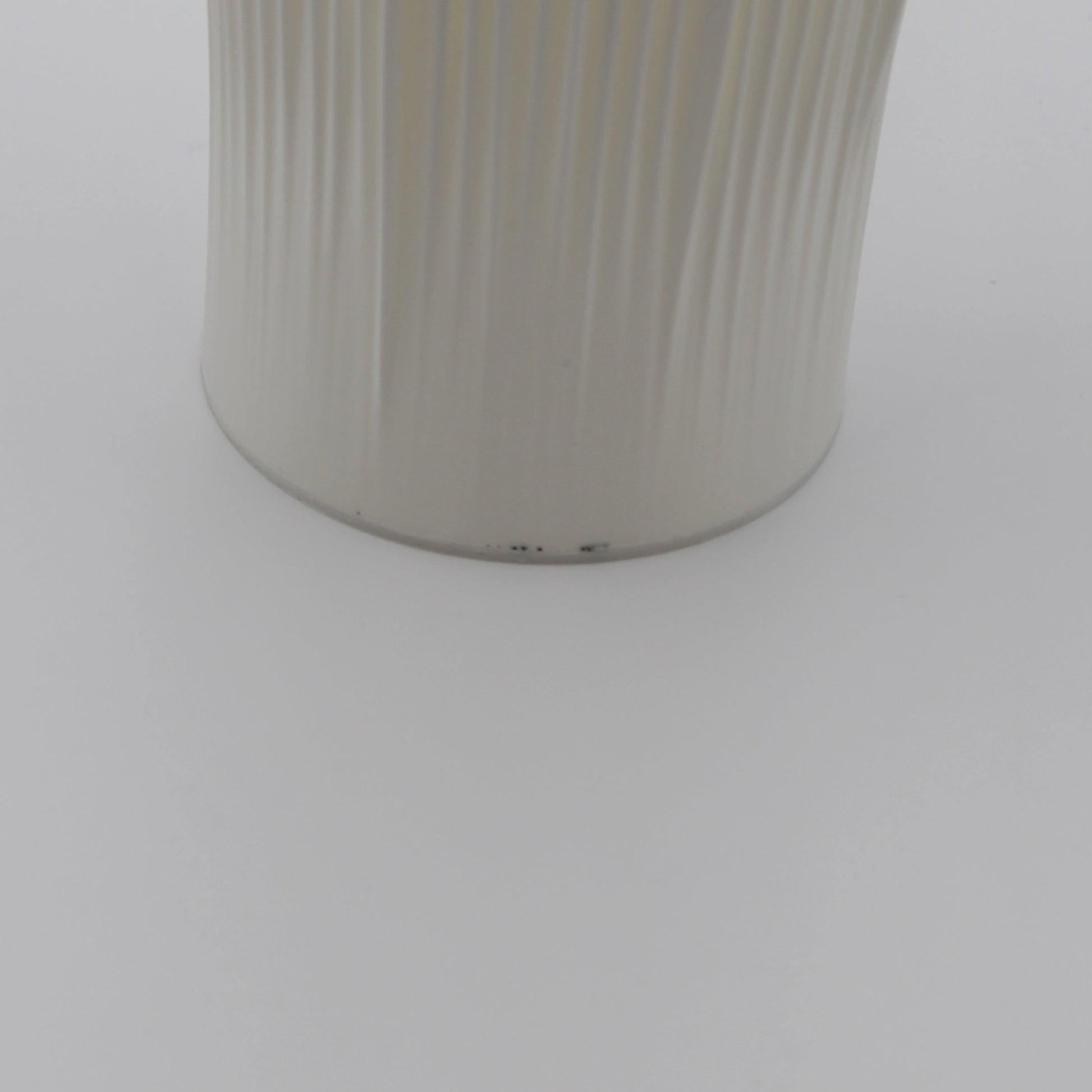 A creme-colored Coral Lamp with minor imperfections near the base.