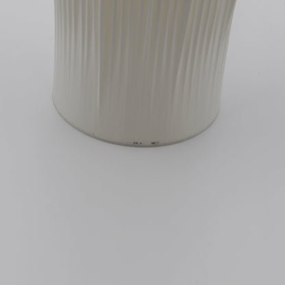 A creme-colored Coral Lamp with minor imperfections near the base.