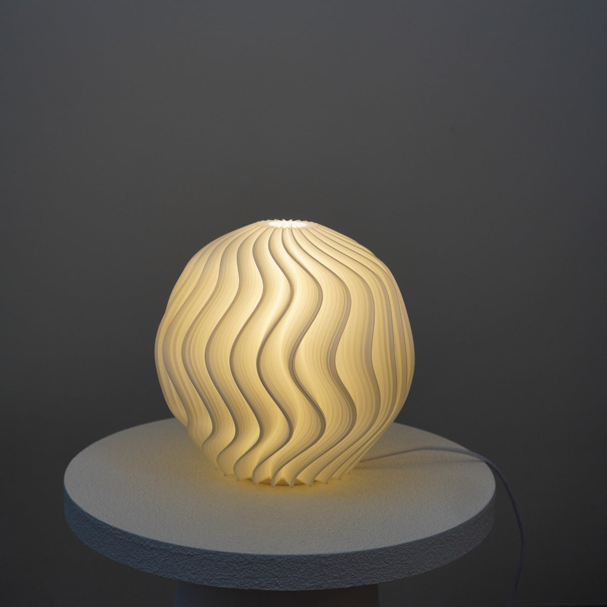 Crème Orb Studio Seconds lamp illuminated