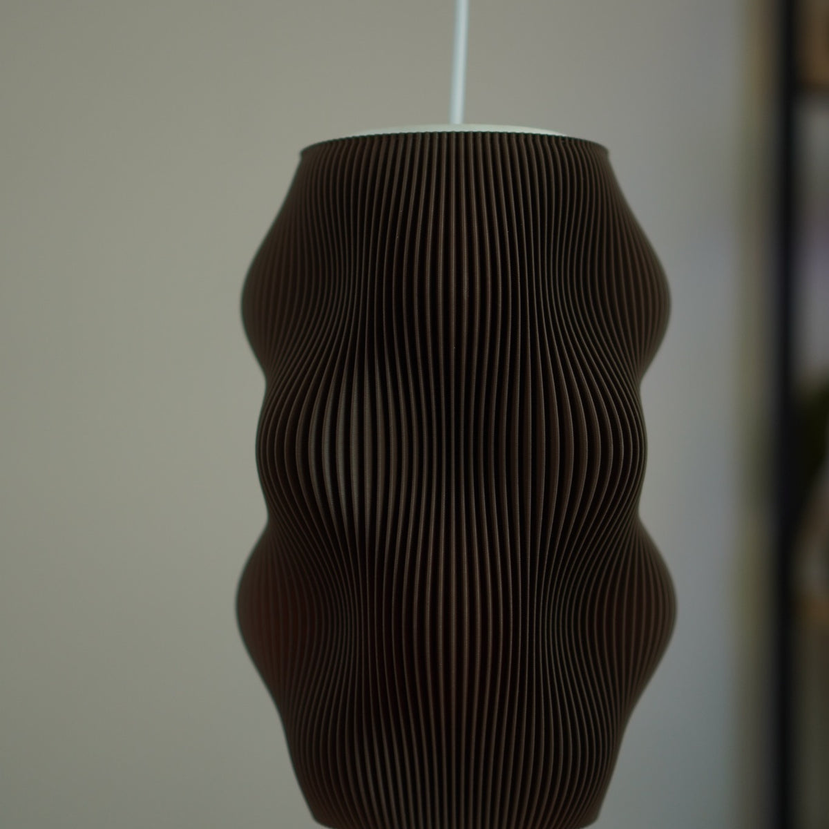 Close-up of Chocolate Harp Echo pendant Studio Edition SE002 switched off