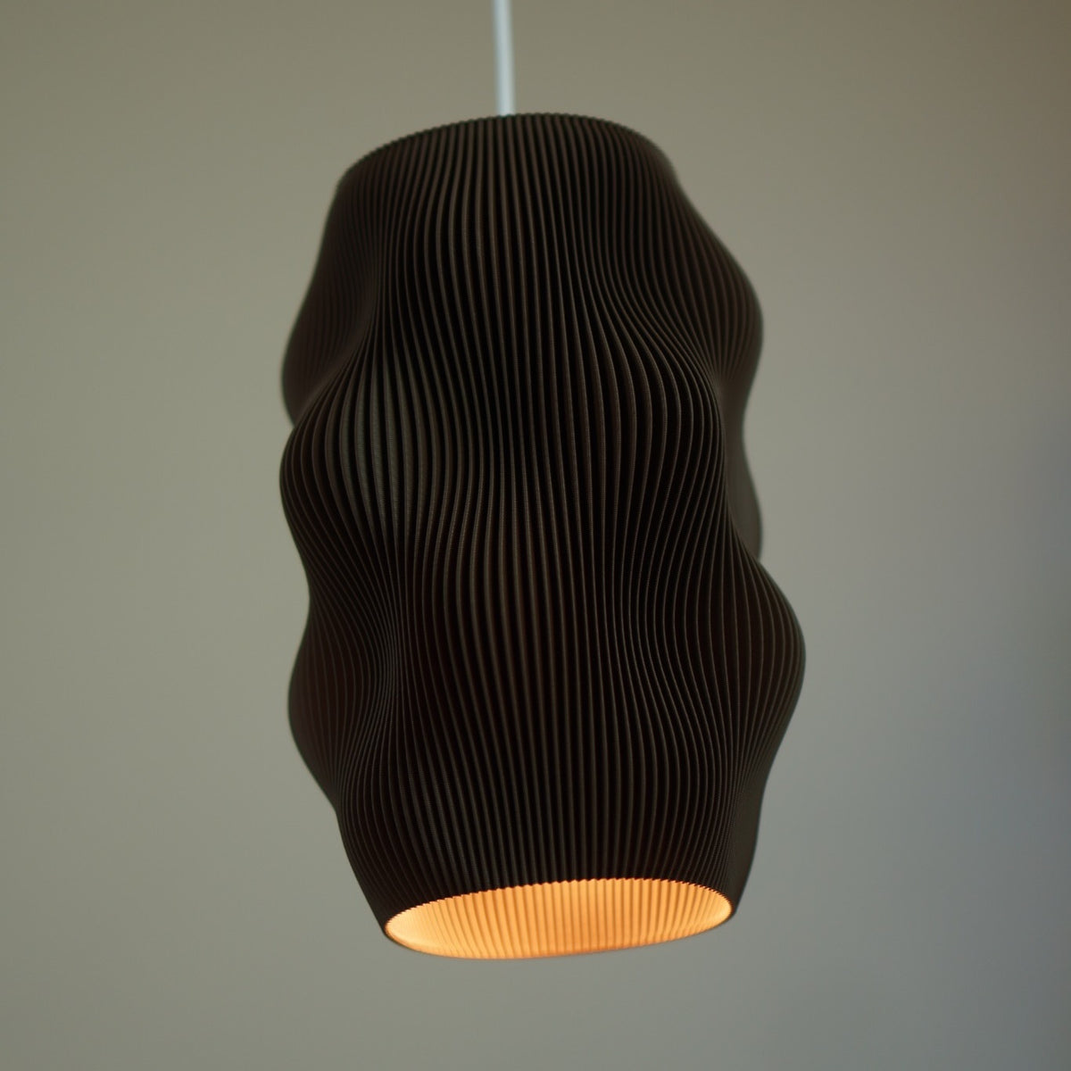 Close-up of Chocolate Harp Echo pendant Studio Edition SE002 illuminated from below