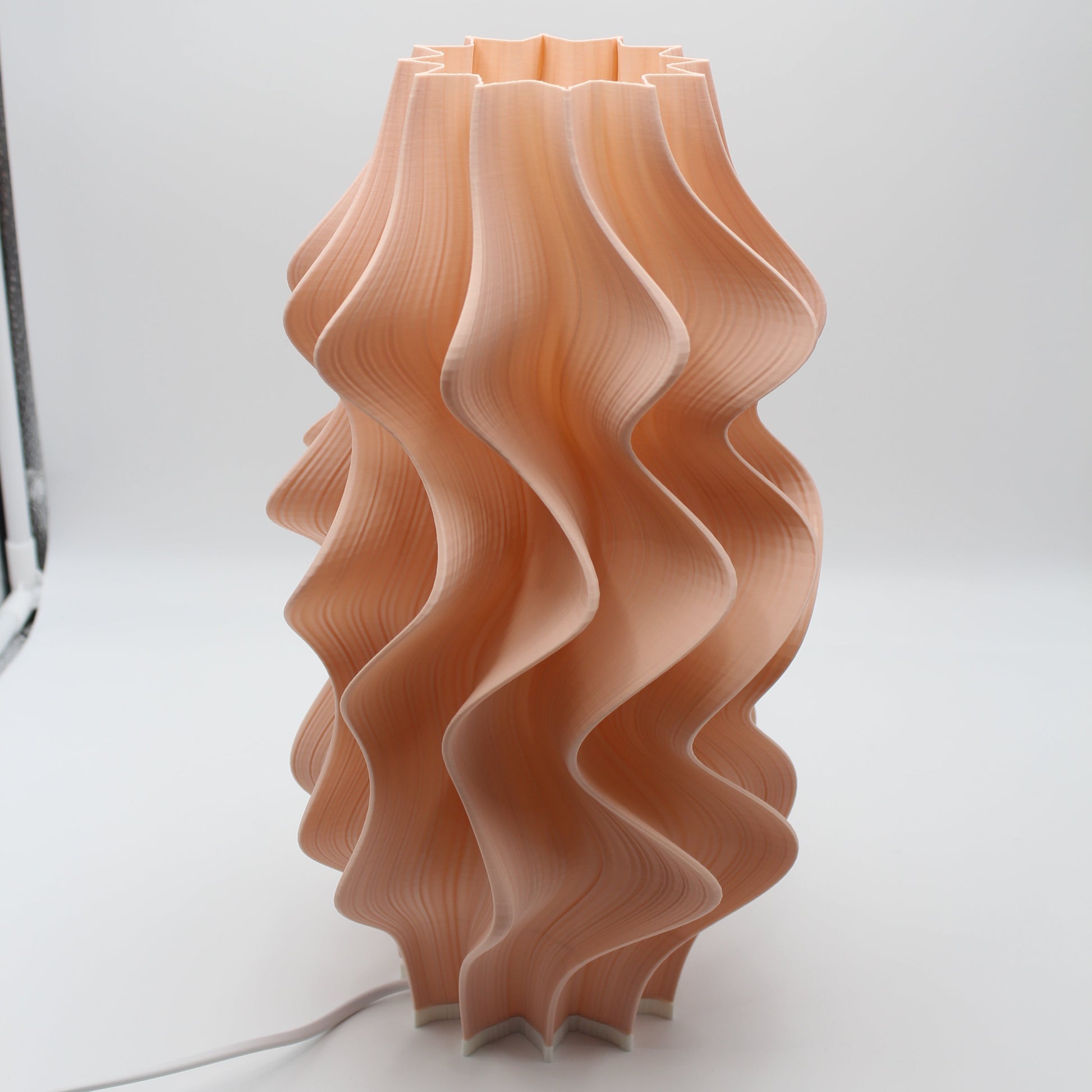 A sculptural Peach Iris Lamp, a seconds piece with a small cosmetic imperfection at the base.