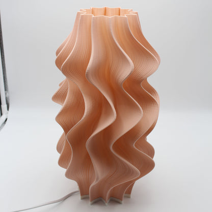A sculptural Peach Iris Lamp, a seconds piece with a small cosmetic imperfection at the base.