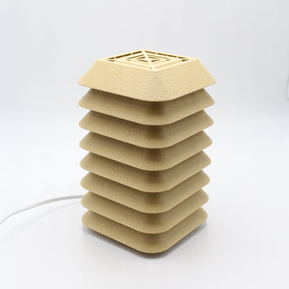 Beige kengo to lamp with geometric design on a white background