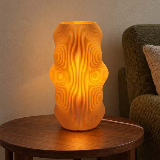 Illuminated Harp Echo lamp on a walnut side table beside an olive chair