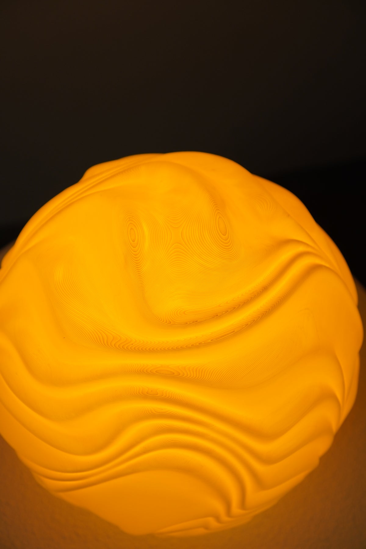 Detail of the flowing ridges on the illuminated Lemon O4 Flow Sculpted Lamp