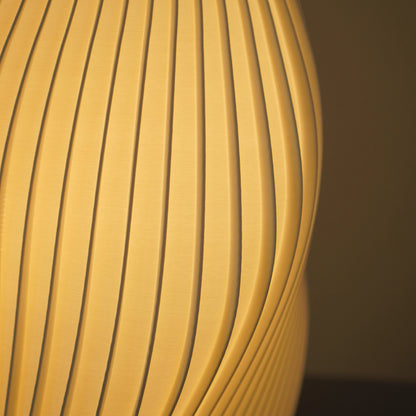 Detail of the Crème Pleat Floor Lamp's curved pleats and fine 3D-printed surface texture.