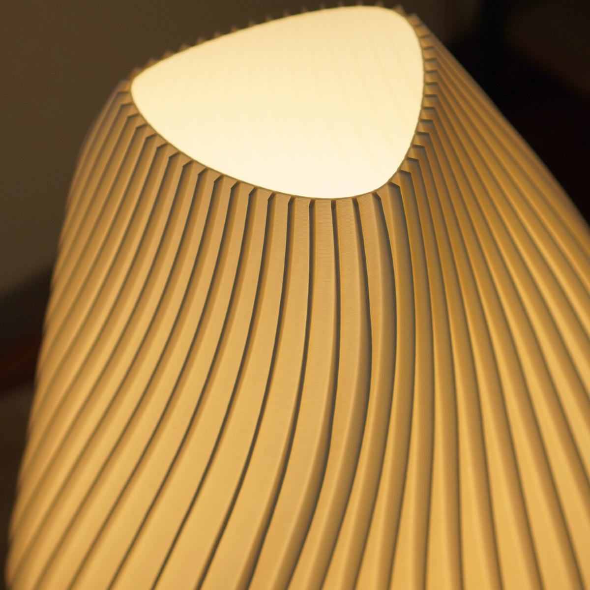Close-up of the upper pleats and warm light on the Crème Pleat Floor Lamp shade.