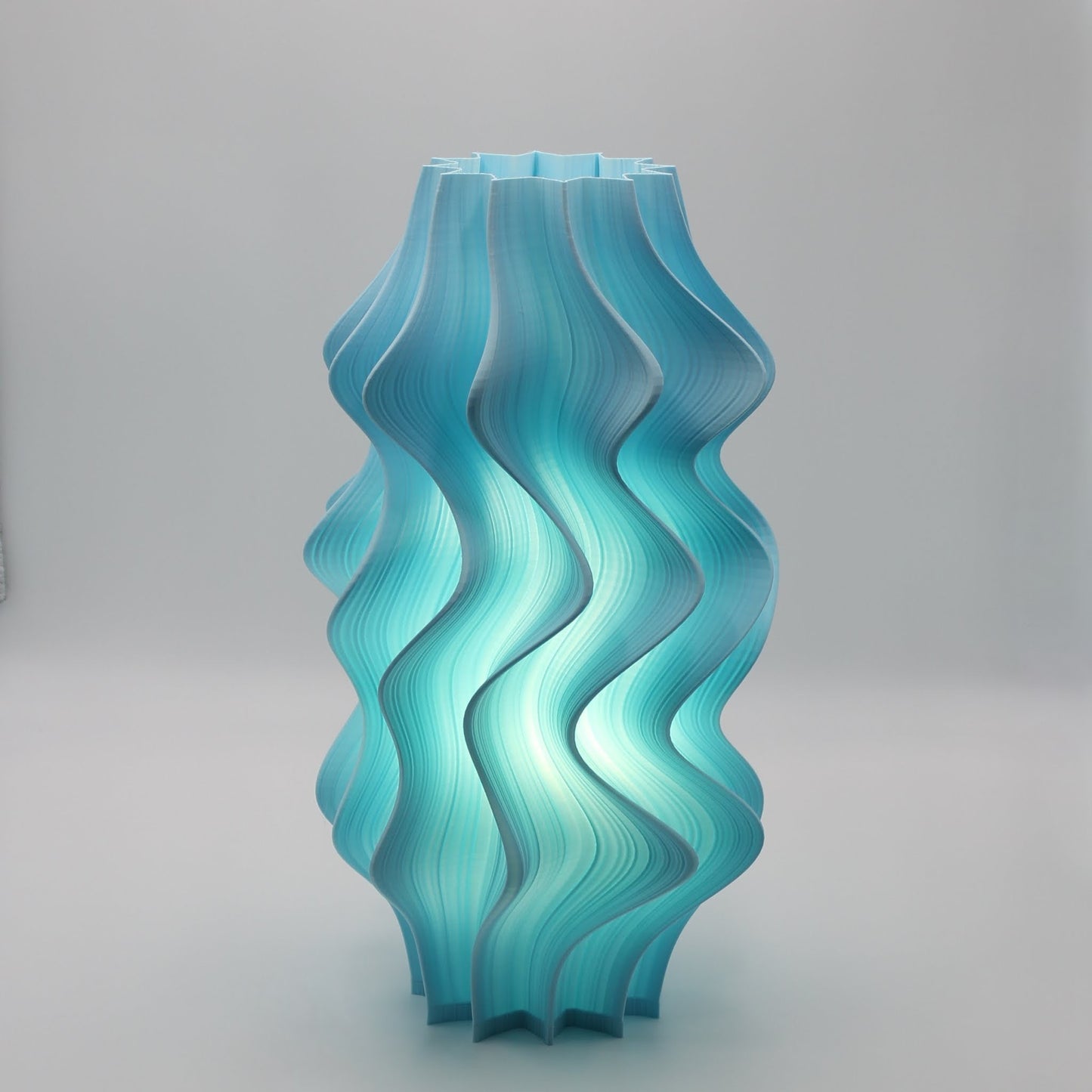 Turquoise wavy Iris Lamp on a gray background